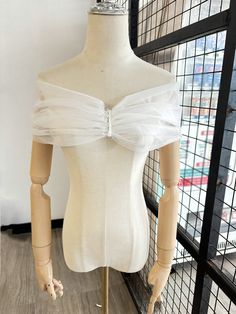 a mannequin wearing a white dress with a bow on it's back