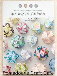 the book features origami flowers and other colorful paper decorations in japanese characters'words