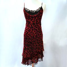 Iconic 1990's Red And Black Betsey Johnson Animal Print Dress With Adjustable Spaghetti Straps And An Asymmetrical Hemline. This Rare Betsey Johnson Dress Is Timeless And Very Flattering To Many Body Types. The Outer Dress Is 100% Silk With A Drape Neckline Which Reveals A Black Underdress With Lace Embellishments That Peak Through At The Neck And Hem. The Layered Skirt Of The Dress Has An Underskirt Of Embroidered Lace That Hangs Beneath The Silk Outer Skirt. The Vintage Dress Is A Size 8 Which Lace Embellishments, Outer Dress, Betsey Johnson Dress, Vintage Betsey Johnson, Black Silk Dress, Animal Print Dress, Betsey Johnson Dresses, Under Dress, Blood Red