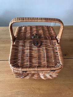 a brown wicker basket sitting on top of a wooden table