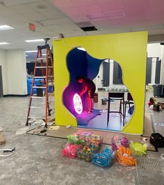 a large photo booth set up in the middle of an office building with neon lights