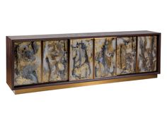 an abstractly designed sideboard with gold and black marbles on it's sides