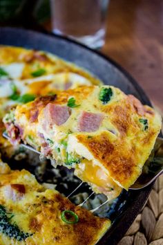 a close up of a pan of food with broccoli and ham on it