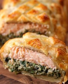 meat and spinach pastry on a cutting board