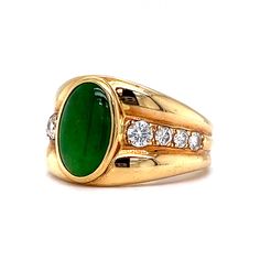 This one of a kind Vintage Inspired Jade & Diamond Ring is crafted in 18k Yellow Gold. A chunky statement ring with Mid-Century style! The jade features a deep forest green hue with rich saturation. The oval shaped cabochon cut jade is set in a bezel. A collection of accent diamonds sparkle at the center of the bold ring. Modern and expertly designed. The ring measures just under 13mm wide. Finished on a tapered and thick 18 karat yellow gold band. A stunning gift for you or your loved one. The Elegant Green Signet Ring With Polished Finish, Luxury Green Gemstone Signet Ring, Luxury Green Signet Ring With Polished Finish, Luxury Green Emerald Signet Ring, Luxury Green Signet Ring For Formal Occasions, Jade Diamond Ring, Bold Rings, Yellow Gold Jewelry, Dream Engagement