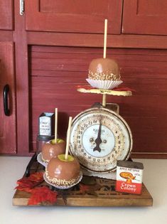 an assortment of desserts are displayed on a tray with apples and other food items