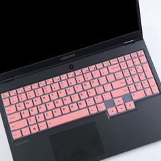 an open laptop computer sitting on top of a white table next to a black keyboard