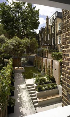 an outdoor garden with steps leading up to the house