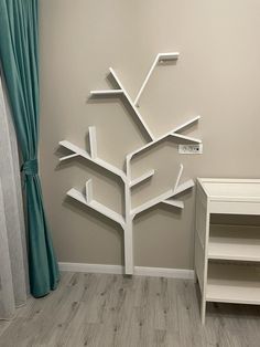 a room with a white tree on the wall