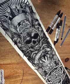 an arm tattoo with a skull and some other items on the table next to it