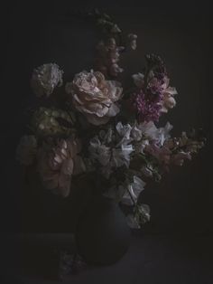 a vase filled with lots of pink and white flowers