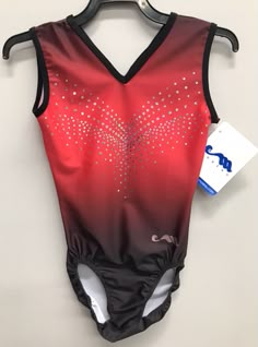 a red and black leotard swimsuit with silver stars on the chest, attached to a hanger