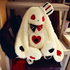 a white stuffed animal sitting on top of a chair