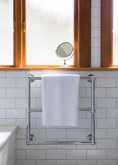 a white towel is hanging on a rack in the bathroom