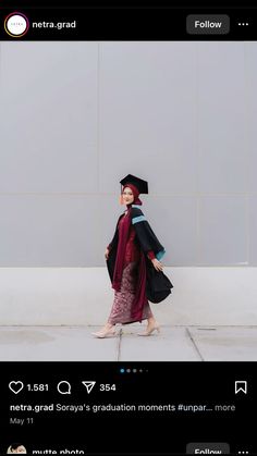 a woman in a graduation gown walking down the street