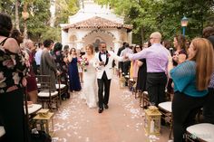 a bride and groom walking down the aisle after their wedding ceremony at disney's animal kingdom