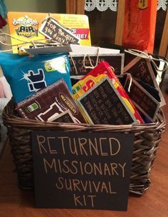 a basket filled with lots of different types of candy and snacks on top of a wooden table