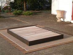 a mattress is laying on the ground in front of a house