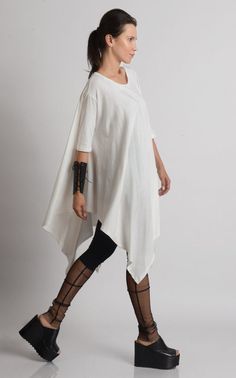 Oversize Long Tunic - METT0105 Be modern in white with this maxi tunic. Because of the loose fit, this top is super easy to wear and perfect for an every day use. It has beautiful asymmetric draping and can easily be paired with a lot of different pants and leggings. Put a pair of heels and a few accessories to make the outfit whole. This asymmetric tunic is made of 100% cotton. NOTE! The color is off white! WHEN YOU PLACE AN ORDER YOU MUST LEAVE A TELEPHONE NUMBER AND CORRECT COORDINATES! WE DO Summer Lagenlook Blouse For Daywear, Lagenlook Blouse For Summer Daywear, Oversized Lagenlook Tunic With Asymmetrical Hem, Cotton Lagenlook Blouse With Asymmetrical Hem, Asymmetrical Hem Cotton Blouse In Lagenlook Style, Summer Lagenlook Blouse, Bohemian Tunic With Asymmetrical Hem For Spring, Spring Bohemian Tunic With Asymmetrical Hem, White Oversized Lagenlook Blouse