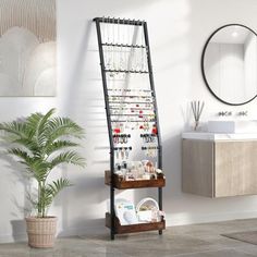 a bathroom with a large mirror, sink and shelving unit next to a potted plant