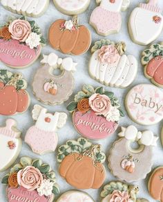 baby shower cookies decorated with pink and white icing on a blue tablecloth background