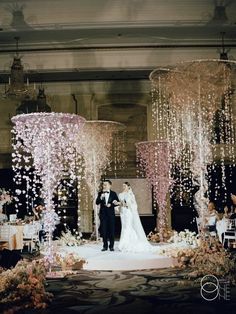 a bride and groom standing in front of an elaborate wedding ceremony