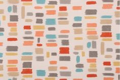 an orange, grey and blue abstract pattern on white fabric with lots of small squares