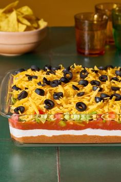 a casserole dish with black olives and cheese