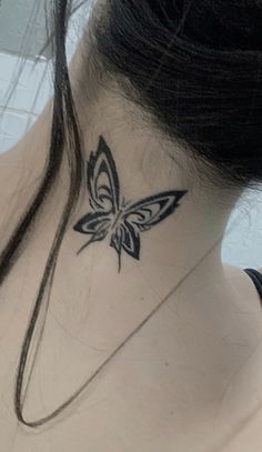 a woman with a butterfly tattoo on her neck