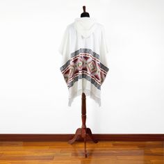 This poncho pullover is made of baby alpaca yarn, one of the finest yarns in the world. It is lightweight, but warm and very soft and won't itch. Colours and patterns might differ slightly from the photo shown as of handmade nature of each item. One size fits most (approx.): 44" W x 34" H (112 cm W x 87 cm H) one size Approx. Weight: 1.2 lbs / 540 g Materials: Baby Alpaca Wool blend Features: Hood, Pullover An alpaca (Vicugna pacos) is a domesticated species of South American camelid. It resembl White Cozy Winter Poncho, White Bohemian Poncho For Winter, Cozy White Poncho For Fall, Casual White Hooded Poncho, Beige Alpaca Poncho One Size, Beige Alpaca One-size Poncho, One Size Beige Alpaca Poncho, Cozy Oversized White Poncho, Poncho Pullover