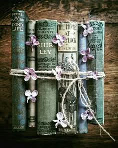 an old book with flowers tied to it