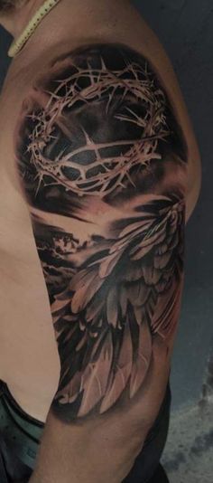 a man with a tattoo on his arm and chest that has a crown in it