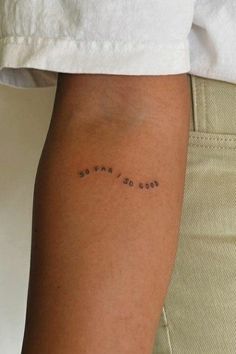 a person with a tattoo on their arm that says god is the only one,