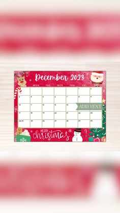 a desk calendar with santa claus and snowmen on the front, in red and green