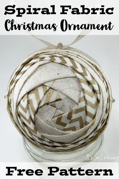 an ornament made out of fabric in a jar with text overlay that reads, spiral fabric christmas ornament free pattern