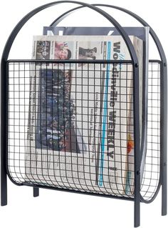 a magazine rack with newspaper in it on top of a white background and black metal frame