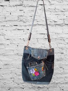 a handbag hanging from the side of a brick wall with flowers painted on it