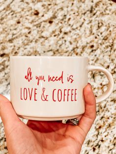 a hand holding a coffee mug with the words all you need is love and coffee