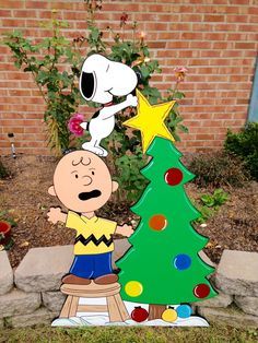 a charlie brown christmas tree with a star on top and a person standing next to it