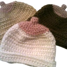 three crocheted hats sitting next to each other