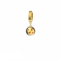 a gold charm with red stars on the front and yellow bottom, sitting against a white background