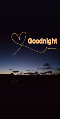 the words goodnight are written in front of a night sky with a heart drawn on it