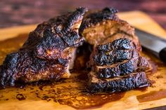 some meat on a cutting board with a knife