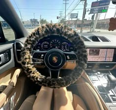 the interior of a car with a steering wheel covered in faux and furry trims