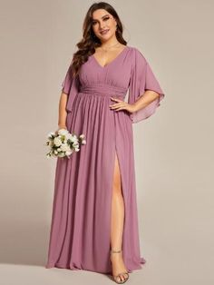 a woman in a long purple dress posing for the camera