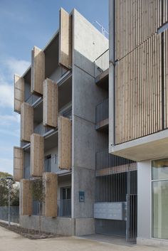 an apartment building with wooden balconies on the side