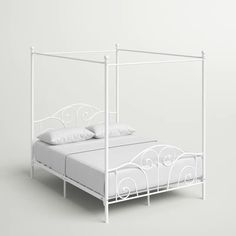 a white metal bed frame with two pillows on the top and bottom, against a gray background