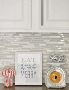 a kitchen counter topped with candy canes next to a clock and peppermint