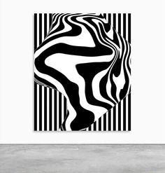 a black and white abstract painting on a wall in an empty room with concrete flooring