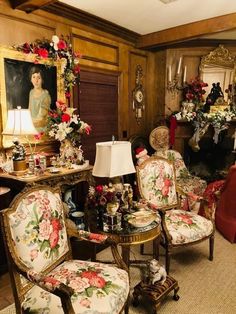 a living room filled with lots of furniture next to a fire place covered in flowers